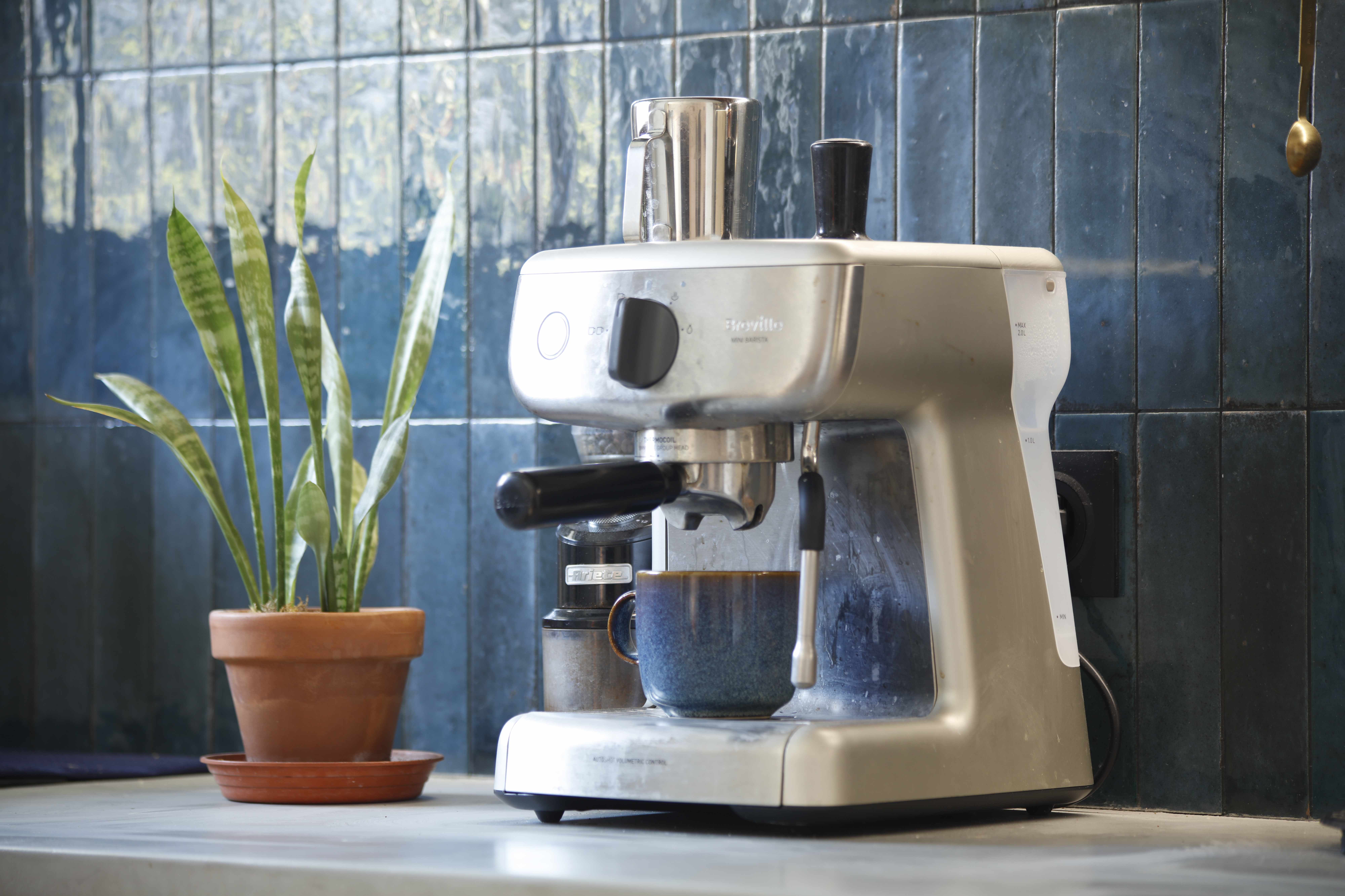 Espresso machine setup with artistic blue tile backsplash