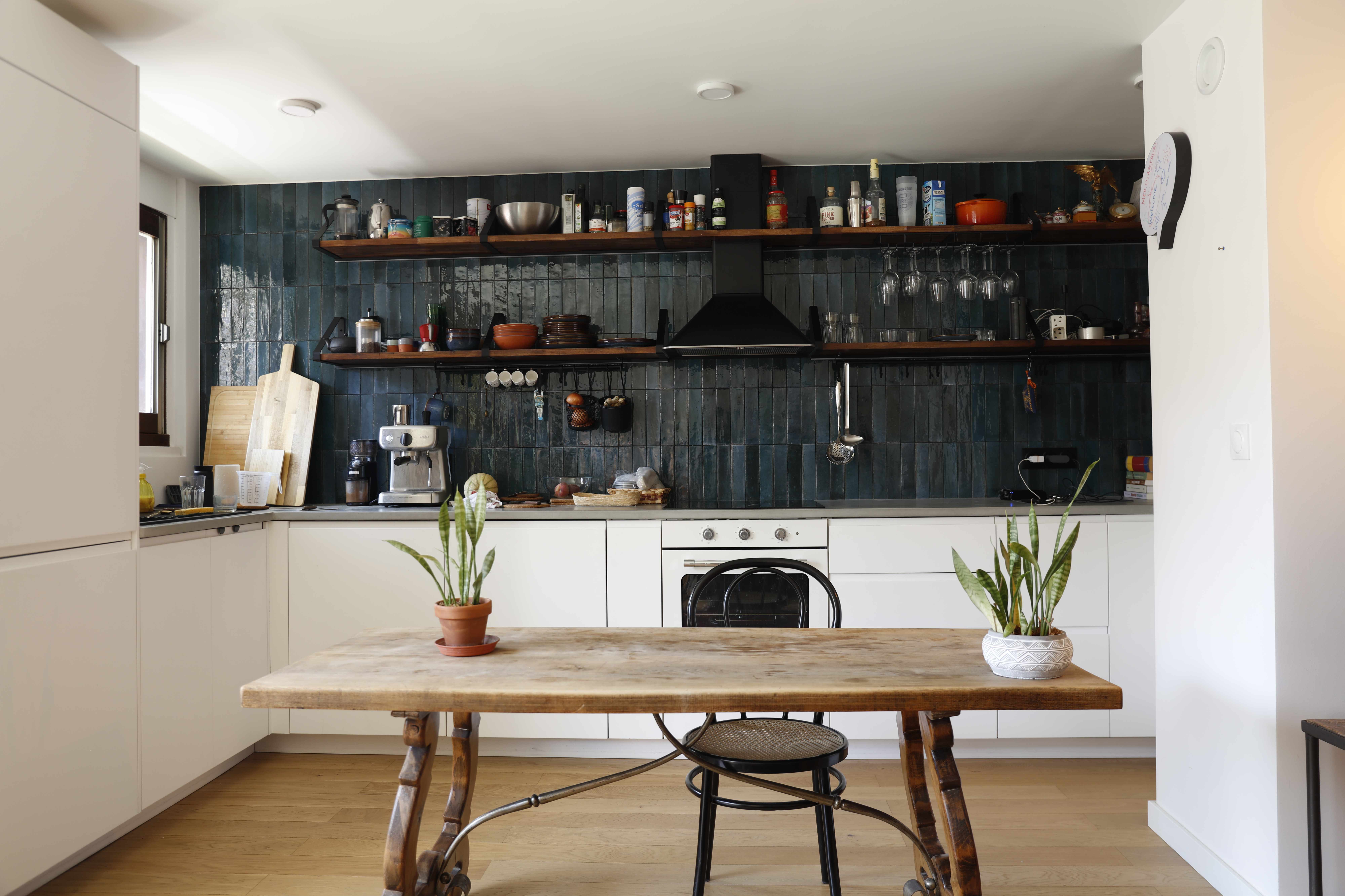 Modern kitchen with blue tiles and open shelving
