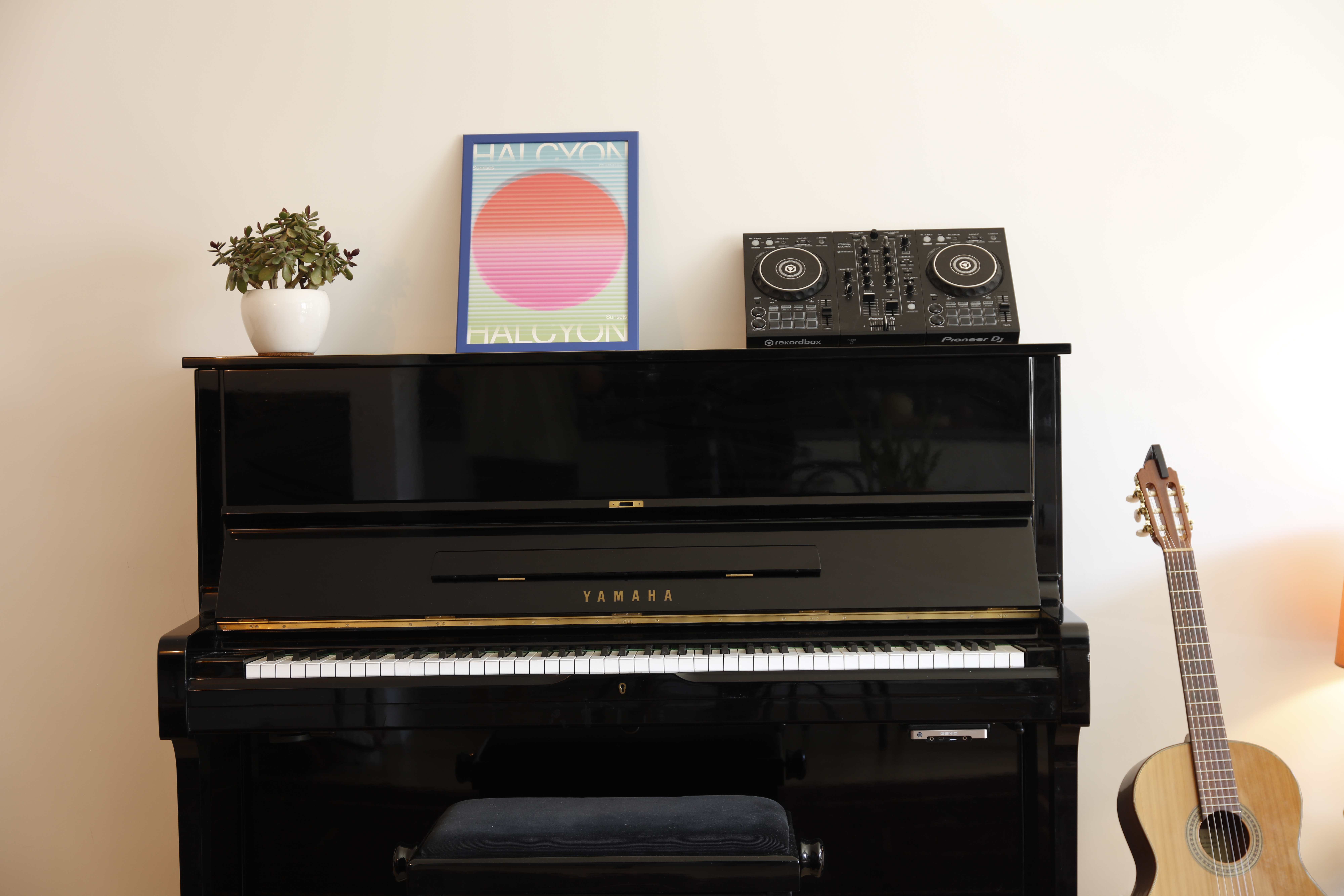 Yamaha piano with DJ controller and artistic posters